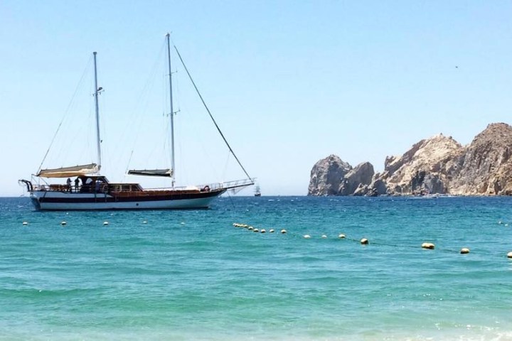 a small boat in a body of water next to the ocean