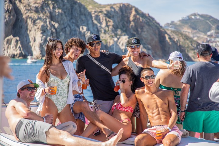 a group of people sitting on top of a mountain