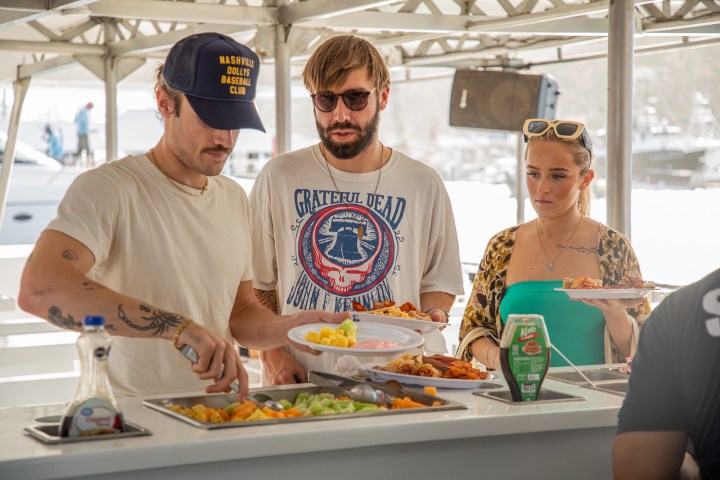 a group of people preparing food in a kitchen