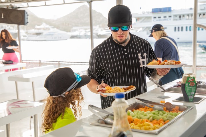 a group of people sitting at a table with food
