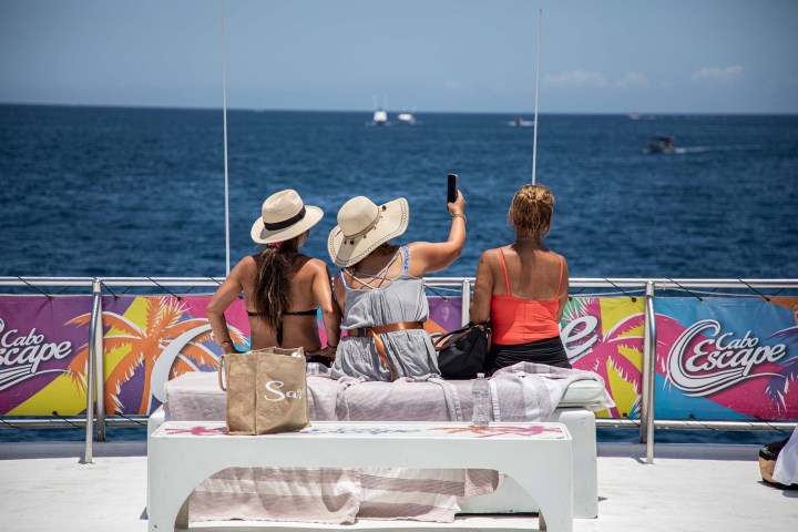 a man holding a kite in a boat on a body of water