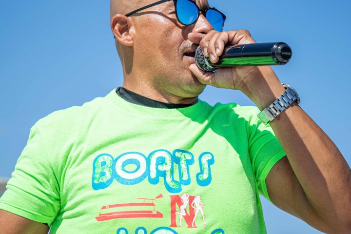 a man wearing a green shirt holding a baseball bat